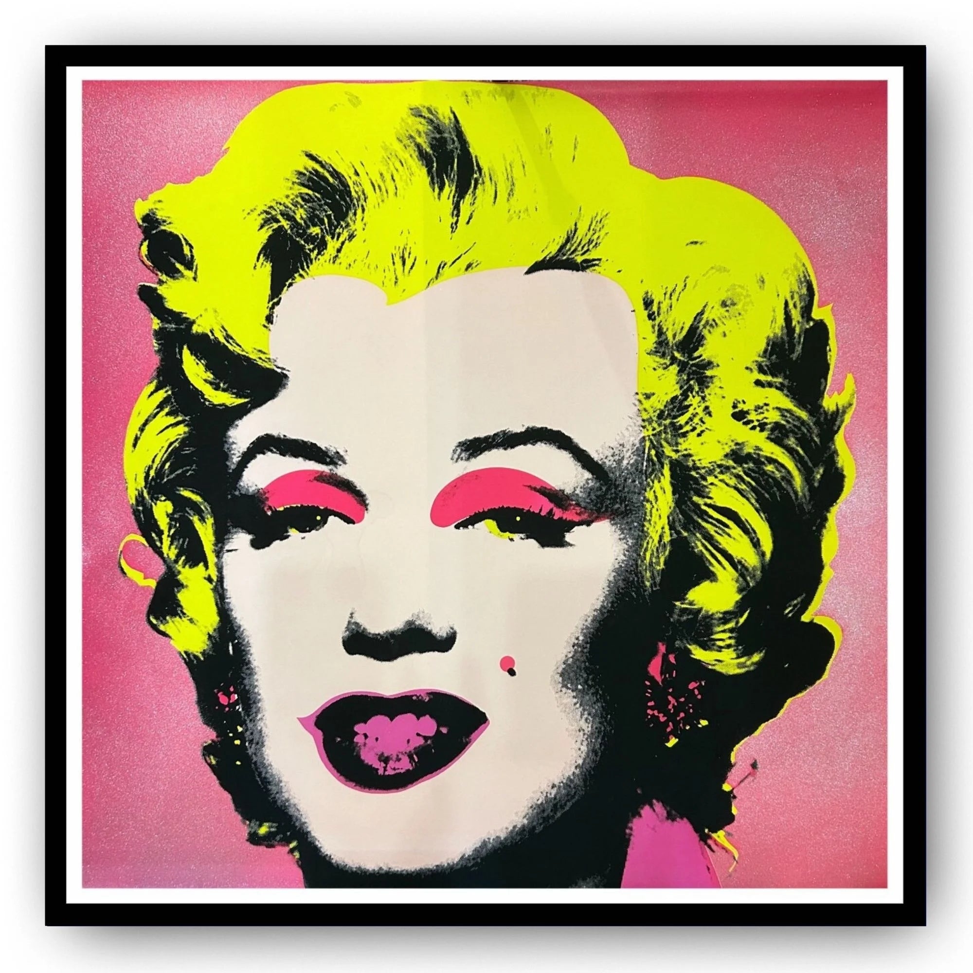 Framed artwork of a famous Andy Warhol pop art portrait Marilyn #31 with diamond dust background with bright colors on a pink background
